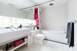 © Jodie Johnson - Contemporary white bathroom of mosaic and terrazzo tiles with red accent