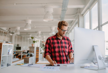 young man working on computer in modern office