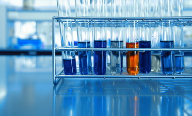 Wall Mural - orange and blue chemical solution in test tubes in science lab