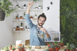 © Westend61 - Plant collector preparing the pendant for an air plant