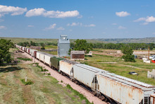 Train Passing Old Grain Elevator In South Dakota