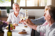 © zinkevych - Group of friends toasting with champagne in the kitchen