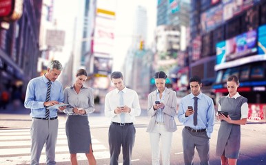 Wall Mural - Composite image of business people using their phone 