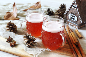 Wall Mural - Two mugs of winter craft beer with foam cap