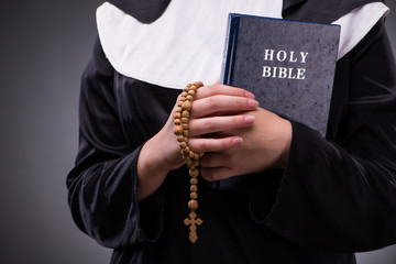 Religious nun in religion concept against dark background