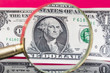 American dollar banknote through a magnifying glass on nice red background