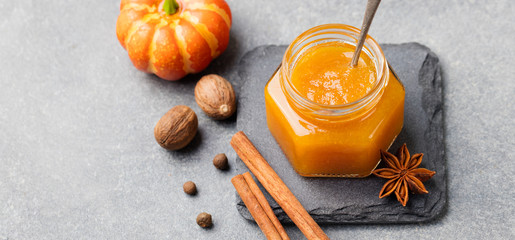 Wall Mural - Pumpkin confiture, jam, sauce with spices on stone table Copy space