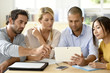 © goodluz - Business people meeting around table in office