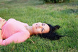 © ribalka yuli - Beautiful woman relaxing at the park lying on grass