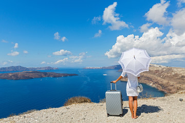 Woman  stands on a hill over the sea