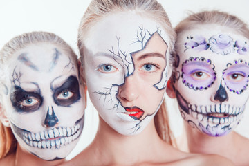 Wall Mural - Three girls with Halloween face art on white background