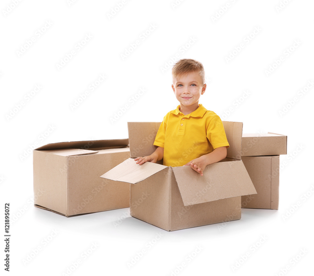 Little boy playing with cardboard boxes isolated on white