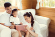 © torwaiphoto - Asian family tablet are playing at home.