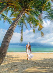 Wall Mural - woman under palm sea