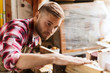 © Syda Productions - carpenter working with wood plank at workshop