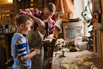 Wall Mural - father and son with drill working at workshop