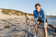 © Sergey Nivens - Young couple on beach training together