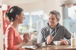 © jackfrog - Young thirties couple having breakfast sitting in the kitchen