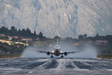 Airplane Takeoff On The Wet Runway In Corfu Airport