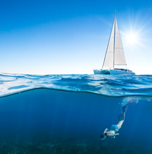 Young Woman Snorkeling Under The Boat
