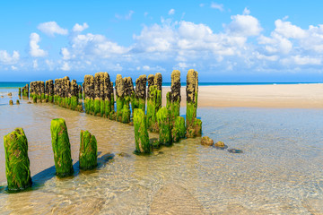 Wooden breakwaters on sandy beach near Rantum village, southern Sylt island, Germany