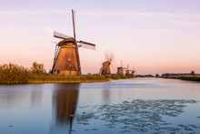 Windmills Of Kinderdijk Near Rotterdam In Netherlands. Colorful Spring Scene In The Famous Kinderdijk Canals With Windmills, UNESCO World Heritage Site