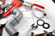 © Africa Studio - Plumbing tools with house plan on wooden background