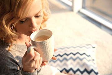 Poster - Beautiful girl drinking coffee at home