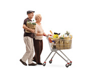 Mature Couple Pushing A Shopping Cart