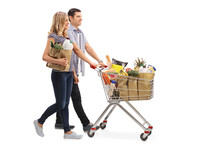 Young Couple Pushing A Shopping Cart