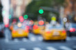 © lazyllama - Yellow taxis crowd the streets of New York City at dusk in a defocus abstract scene of green traffic lights and red tail lights