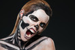 © Drobot Dean - Woman with frightened halloween makeup and opened mouth shouting