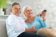 © pikselstock - Senior couple with remote control