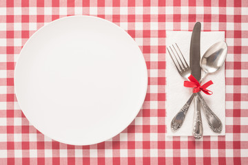 Wall Mural -  Empty plate and cutlery on a table 
