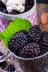 Wall Mural - Cup of fresh natural blackberries with leafs