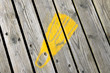 Yellow swim fin painted footprint on Southwold Pier, UK