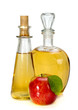 apple cider vinegar in a glass vessel and red apple