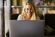 © Kike Arnaiz/ADDICTIVE STOCK - Smiling blonde woman using laptop