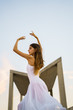 © Kike Arnaiz/ADDICTIVE STOCK - Beautiful brunette ballerina in white performing dance against c