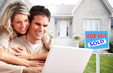 Poster - Couple with laptop near new house.