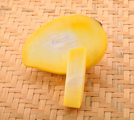 ripe yellow mangoes fruit with green mango leaf in wooden backgr