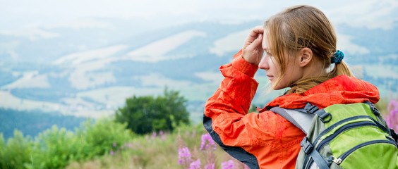 Wall Mural - young woman hiking in the mountains