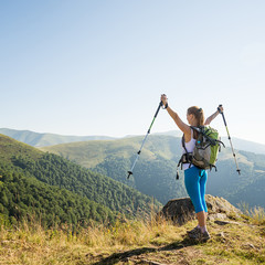 Wall Mural - young woman hiking in the mountains
