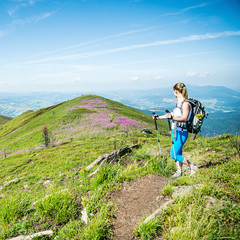Wall Mural - young woman hiking in the mountains