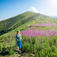 Wall Mural - young woman hiking in the mountains