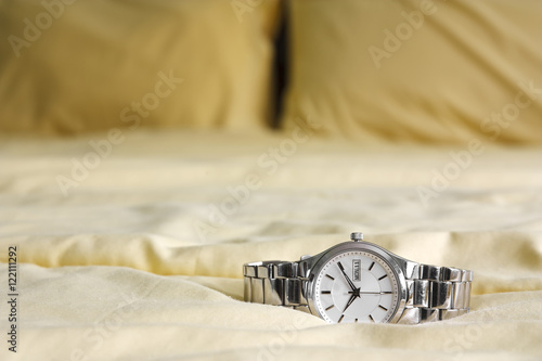 silver watch on yellow bed Canvas