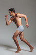 © Drobot Dean - Portrait of a confident naked athletic man in underwear posing