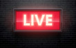 glowing live red sign isolated on black brick wall