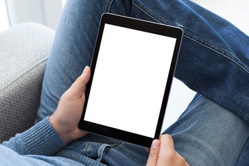 man in jeans sitting holding tablet computer with isolated scree