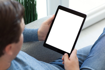 man in jeans sitting and holding tablet computer isolated screen